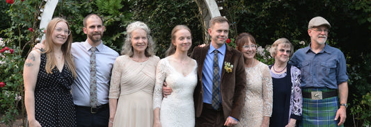 The bride and groom are surrounded by loving family members.