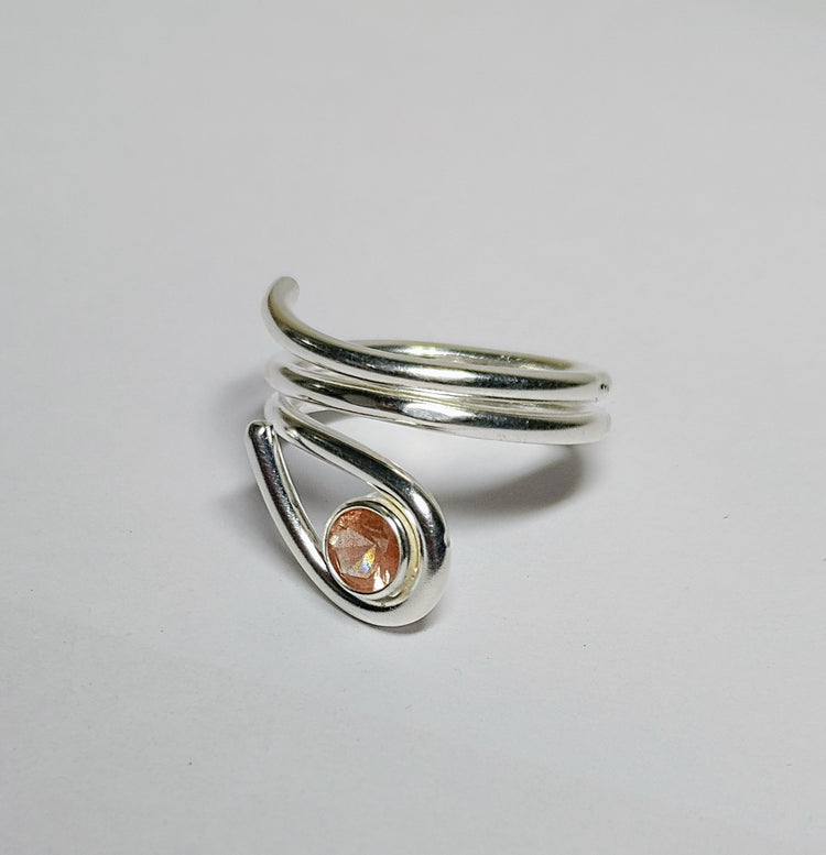 Silver ring with Oregon sunstone on a light gray background