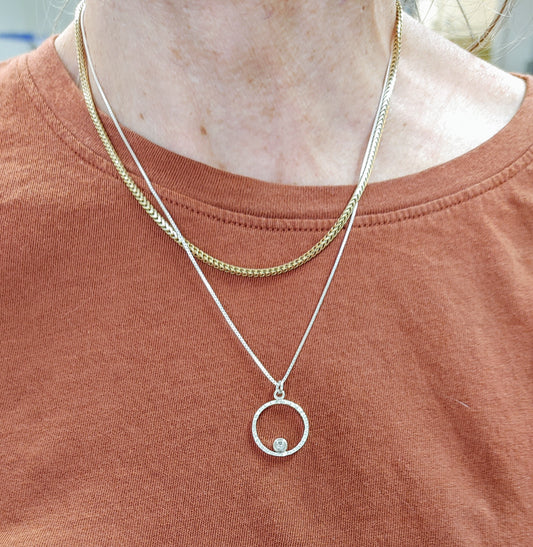 Silver orbit pendant champagne on neck