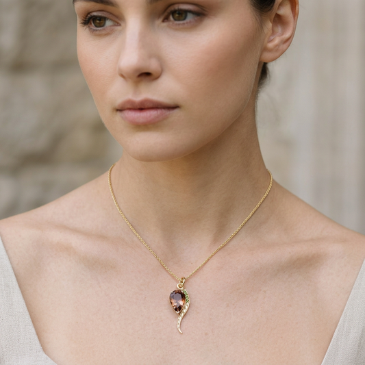 Full-body shot of a model showcasing the Oregon Sunstone necklace on a delicate yellow gold wheat chain against a neutral background, emphasizing elegance and craftsmanship.
