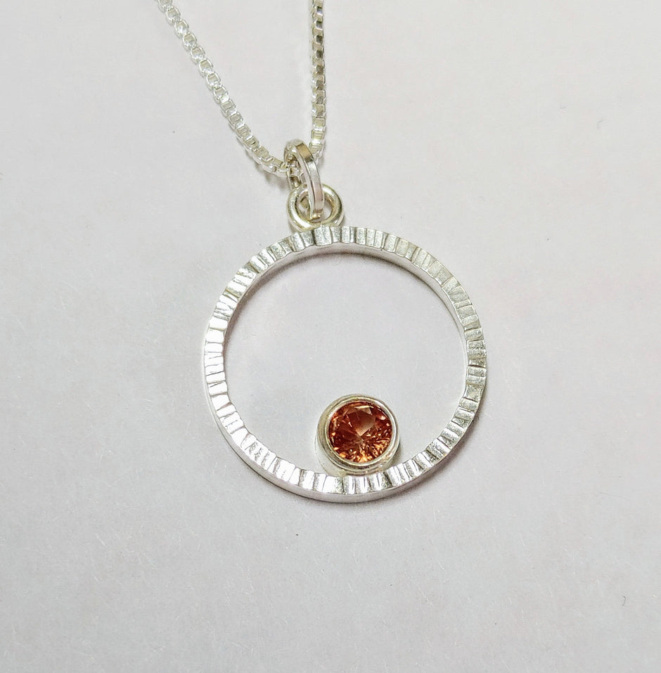 Textured silver pendant with Sunset Oregon sunstone.