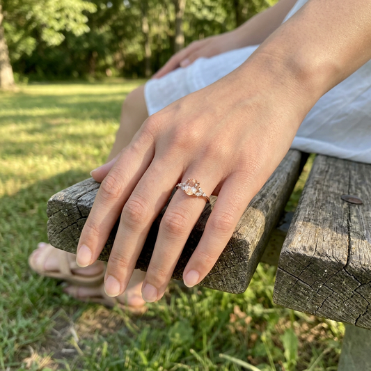Model wearing the Mkayla Sunstone Engagement Ring outdoors, showcasing its delicate design, petite size, and sparkle in natural daylight