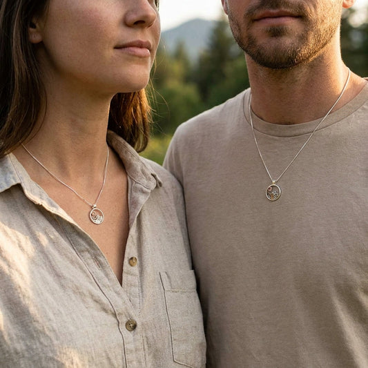 Female model in boho outfit wearing sterling silver mountain necklace with Oregon Sunstone in a relaxed outdoor scene.