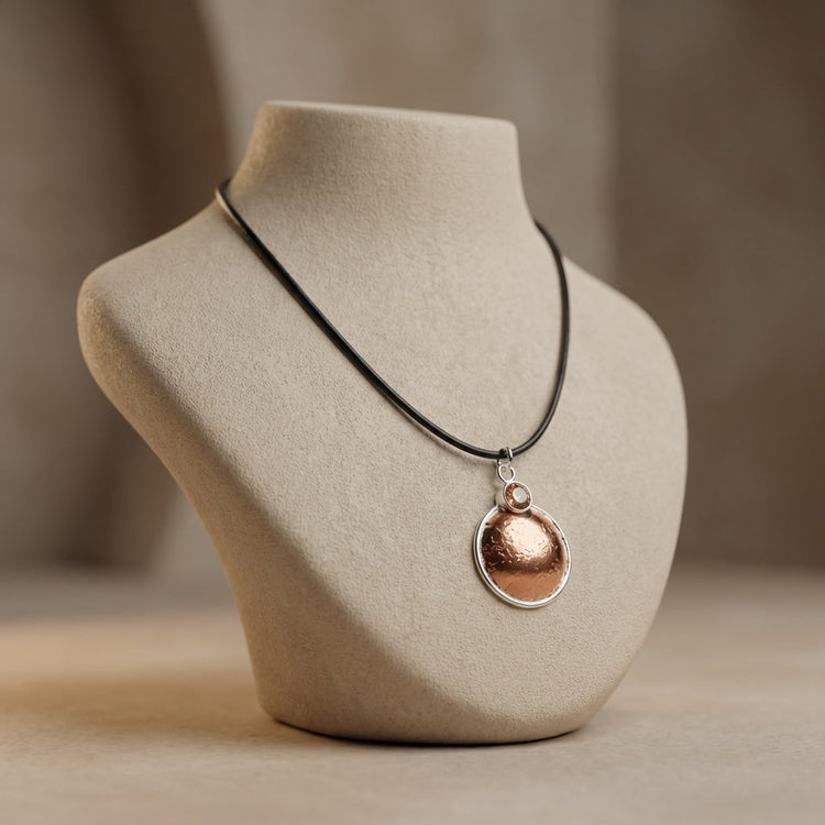 Profile shot of the handcrafted Copper-Silvermoon Necklace on a ceramic bust, emphasizing intricate micro-texture and warm colors.