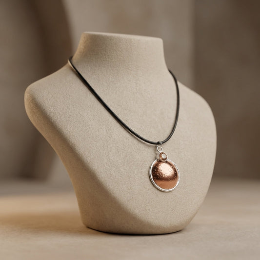 Profile shot of the handcrafted Copper-Silvermoon Necklace on a ceramic bust, emphasizing intricate micro-texture and warm colors.