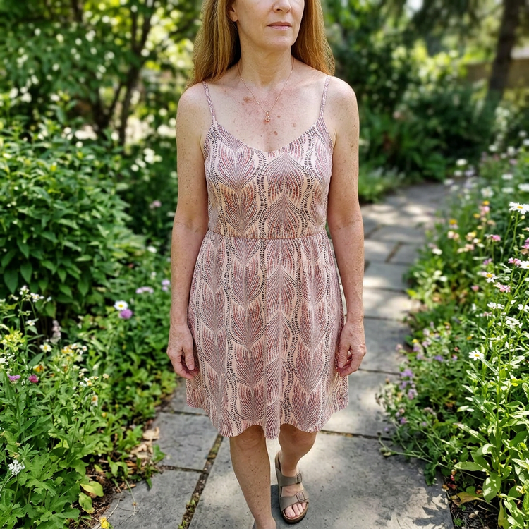 Full-body shot of a model wearing a Peach Oregon Sunstone necklace on a natural background, highlighting the delicate chain and fiery gemstone in daylight.