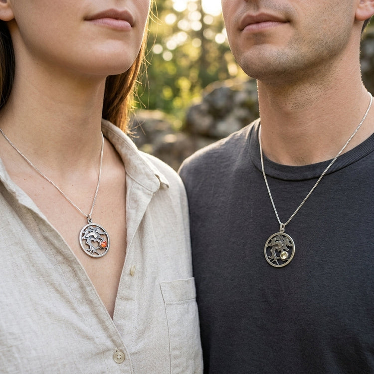 Model's hand holding a silver ring with vibrant Oregon Sunstone, showcasing fine craftsmanship and gemstone's natural color outdoors.
