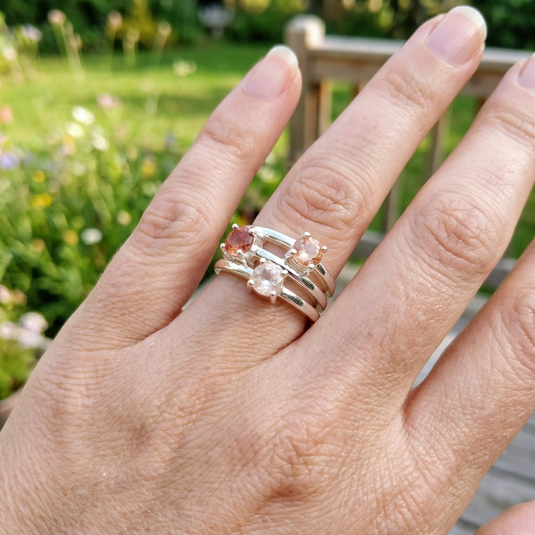 Elegant woman wearing silver Oregon Sunstone Rainbow Ring outdoors in natural light, showcasing everyday jewelry style.