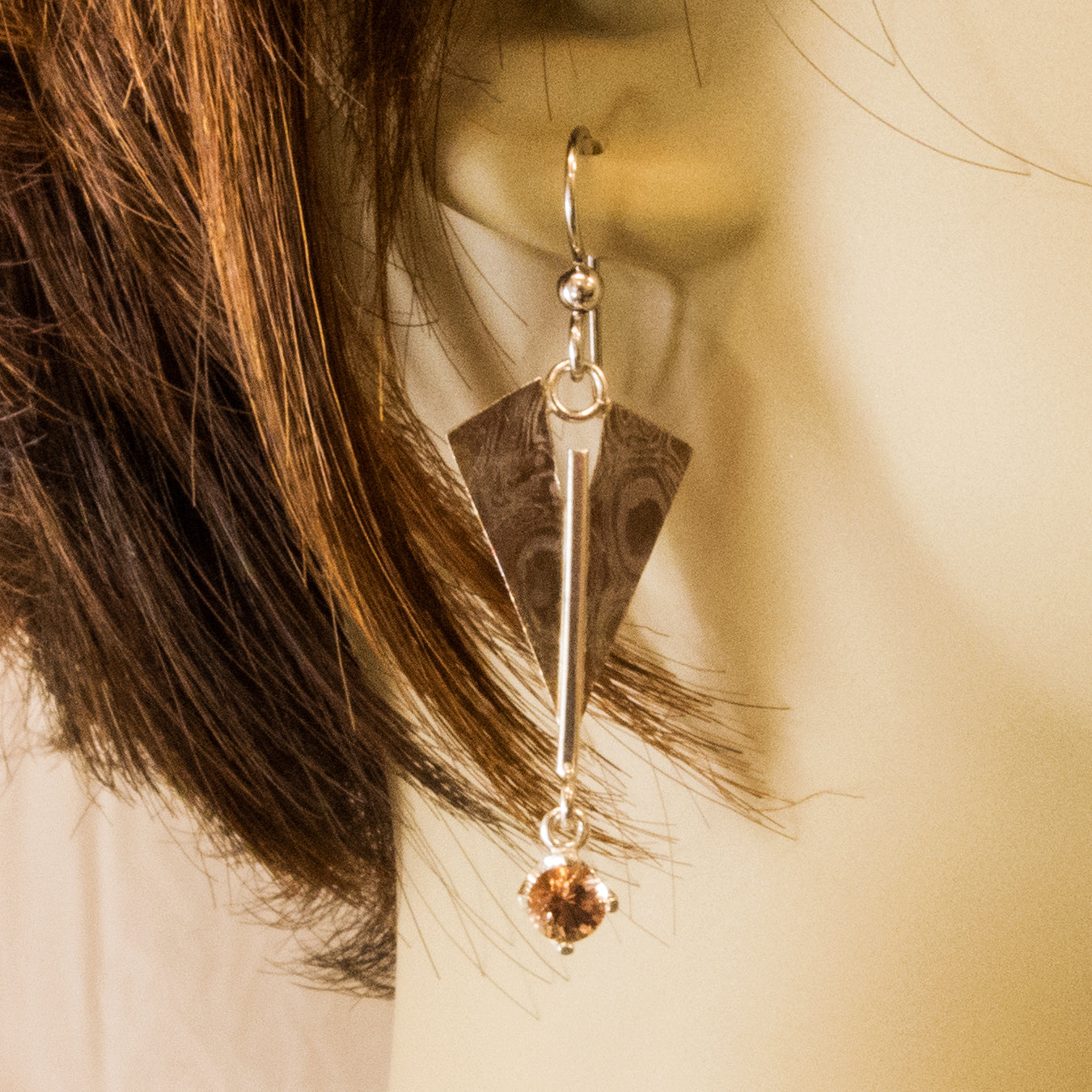 Mokume Sunstone dangle earring on ear